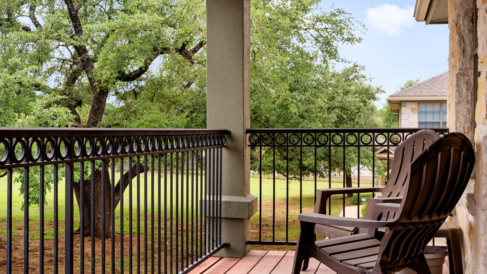 14815 Avery Ranch Boulevard, Unit 1401 Austin, TX 78717 - Photo 10 of 38 Covered porch with wood-finish flooring, wrought iron railing, stone pillar, and stucco column