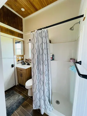 a bathroom with a shower curtain and a sink