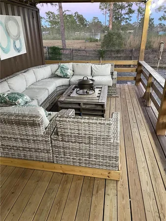 a view of a balcony with couch and wooden floor