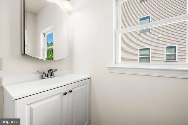 a bathroom with a sink vanity and a mirror