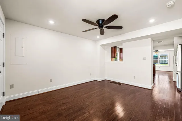 a view of empty room with wooden floor