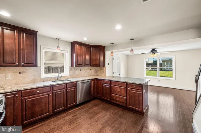 a large kitchen with wooden floors and wooden cabinets