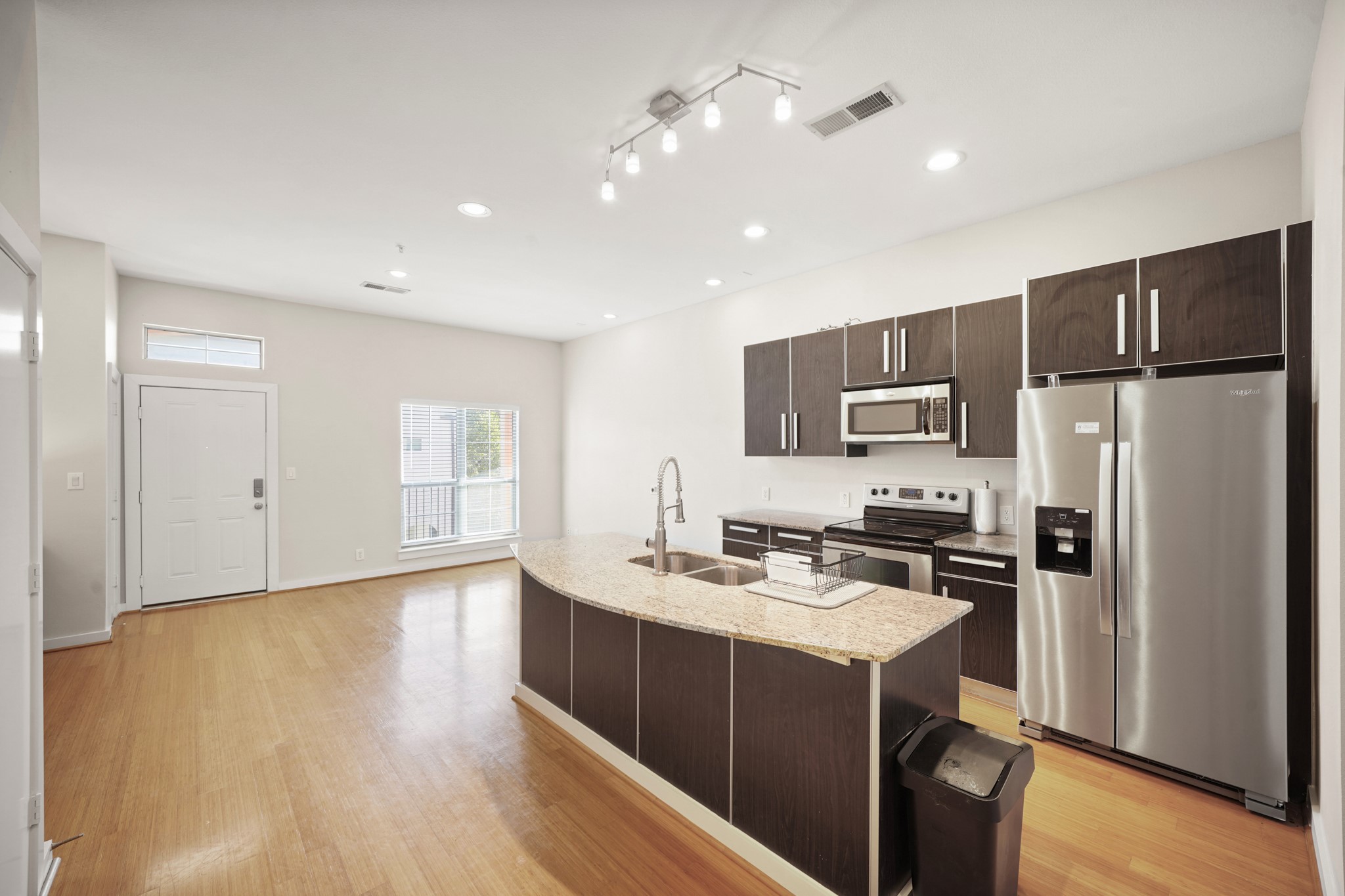806 Jackson Hill Street, Unit 302 Houston, TX 77007 - Photo 12 of 26 a kitchen with a refrigerator a stove top oven and a center island