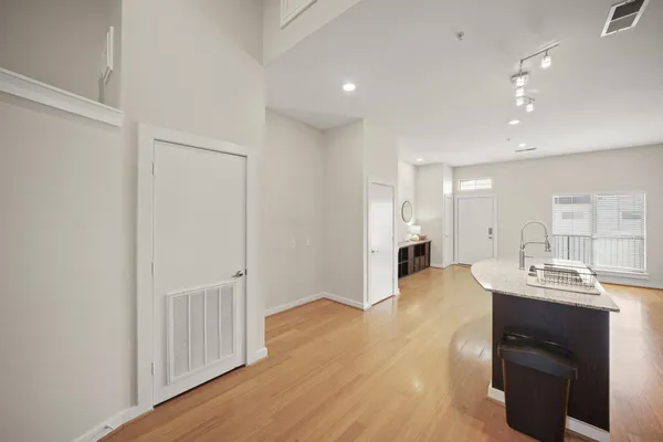 a view of a kitchen counter space and wooden floor