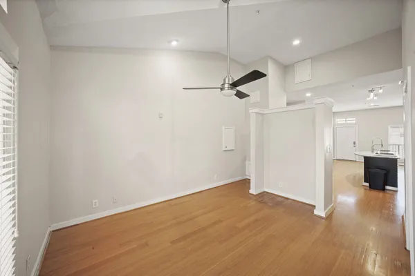 wooden floor in an empty room with a kitchen