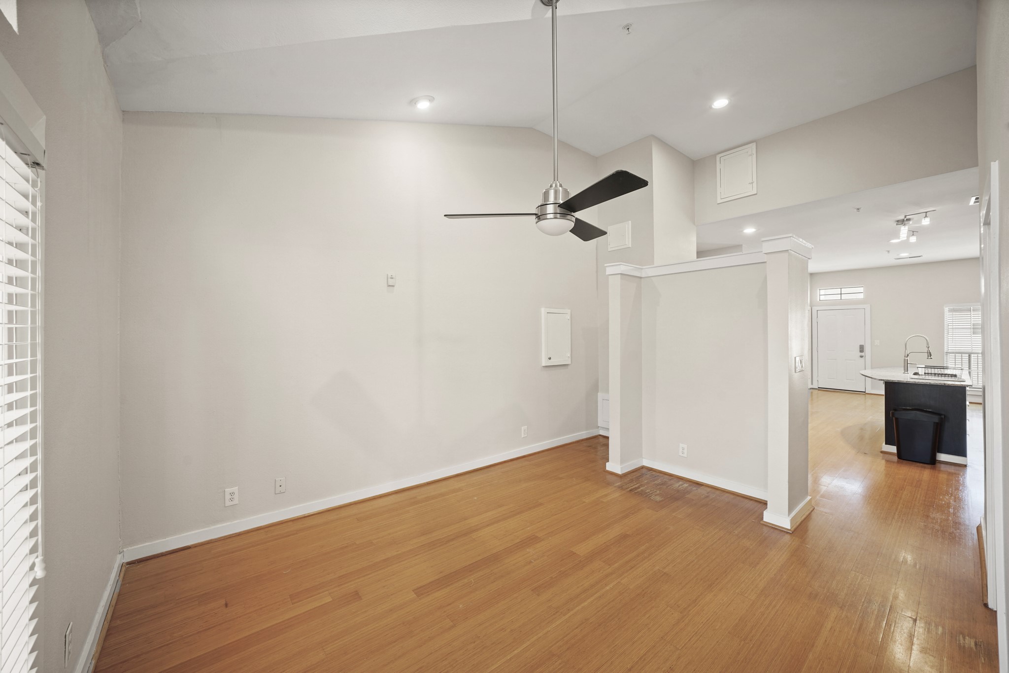 806 Jackson Hill Street, Unit 302 Houston, TX 77007 - Photo 16 of 26 wooden floor in an empty room with a kitchen