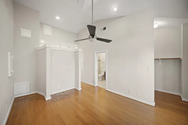 a view of an empty room with wooden floor
