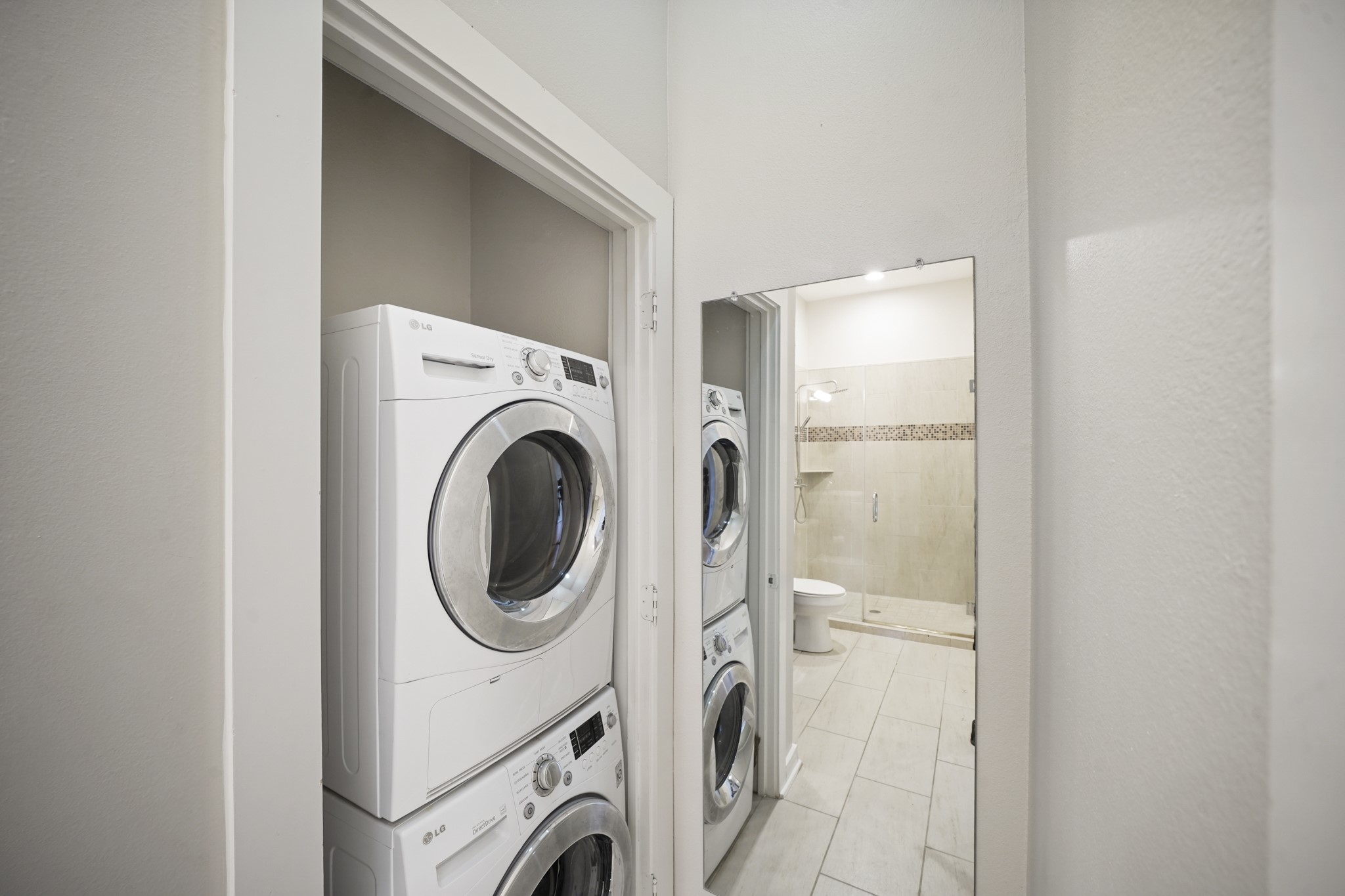 806 Jackson Hill Street, Unit 302 Houston, TX 77007 - Photo 20 of 26 a view of a storage & utility room with dryer and washer