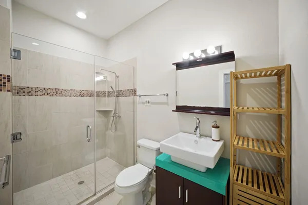 a bathroom with a sink toilet and shower