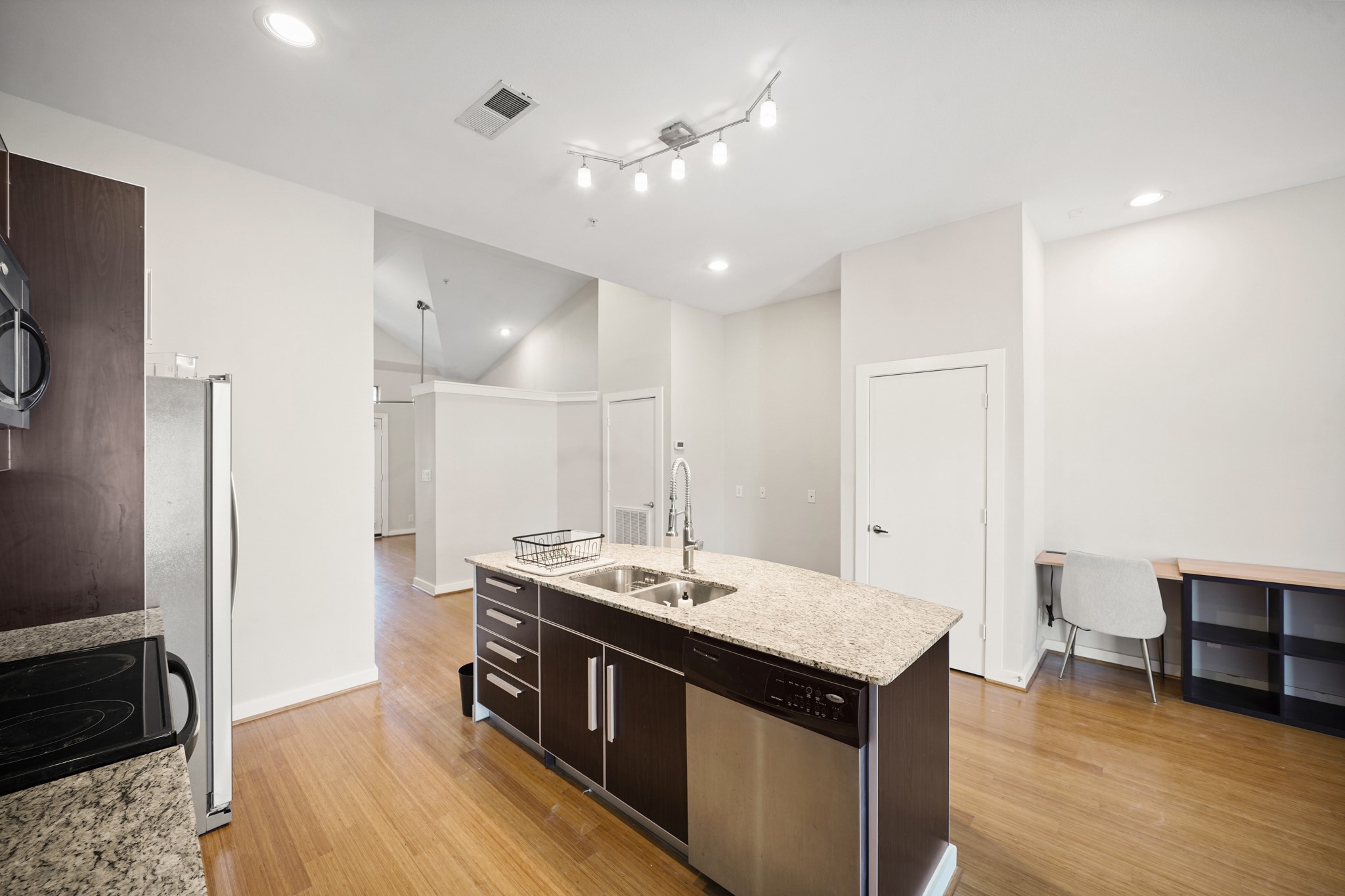 806 Jackson Hill Street, Unit 302 Houston, TX 77007 - Photo 8 of 26 a kitchen with a stove a refrigerator and a sink