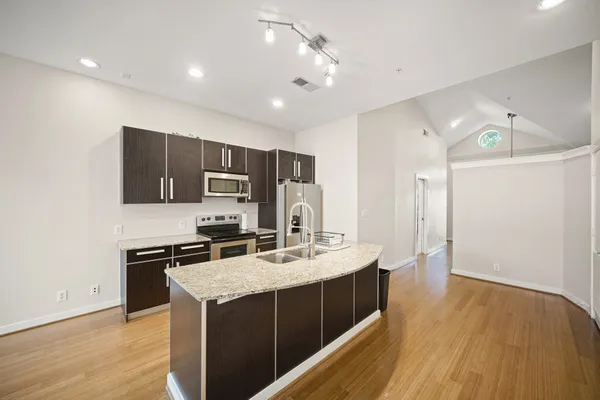 a kitchen with a sink stove and refrigerator