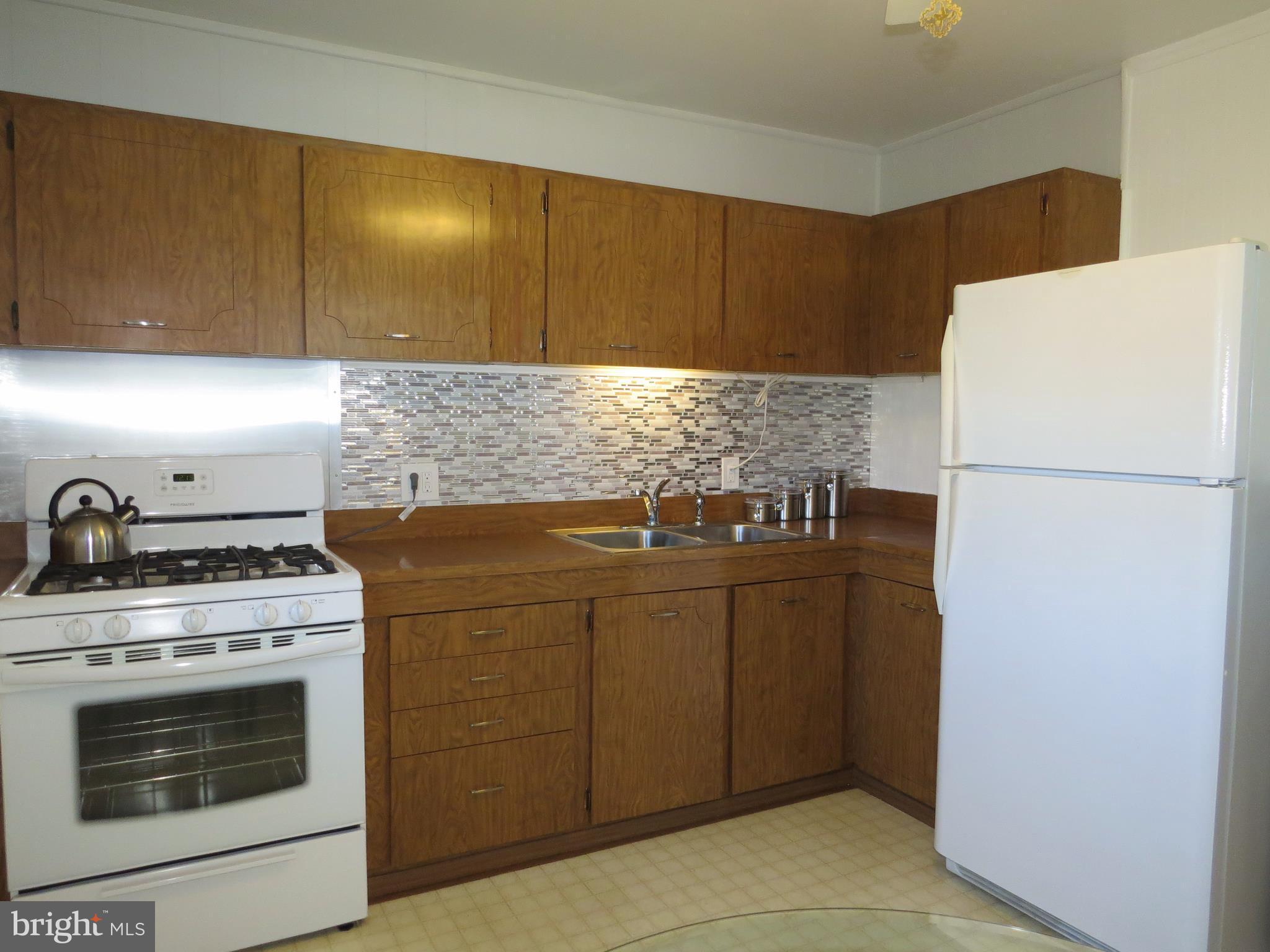311 Highfalcon Road Reisterstown, MD 21136 - Photo 2 of 24 a kitchen with granite countertop a stove and a refrigerator
