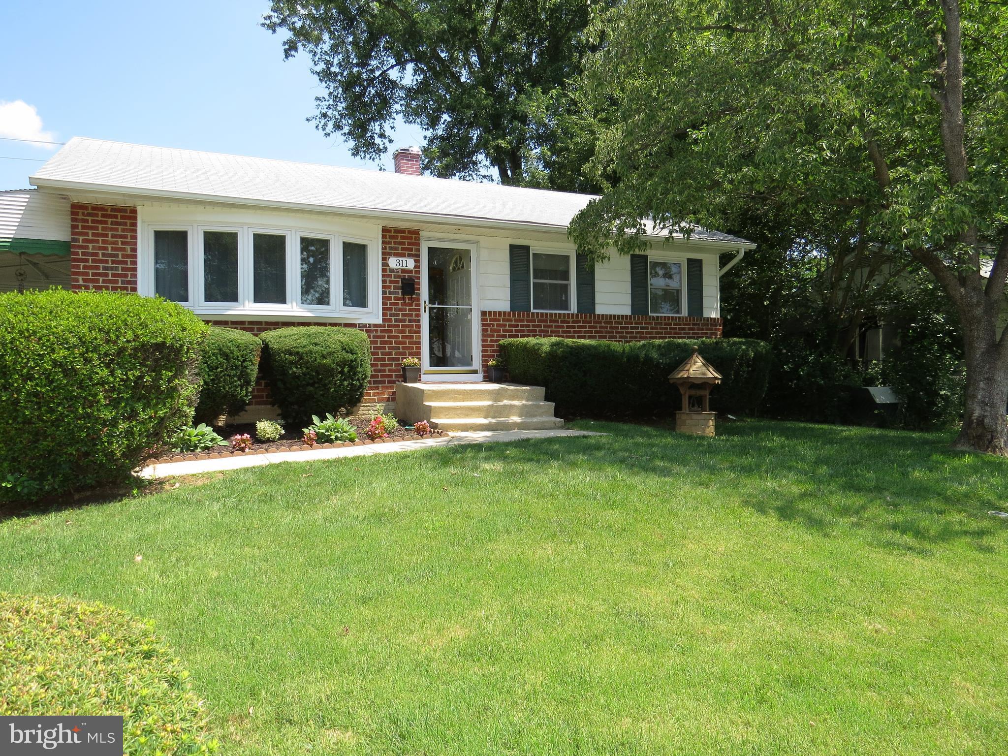 311 Highfalcon Road Reisterstown, MD 21136 - Photo 19 of 24 a front view of a house with a yard and green space
