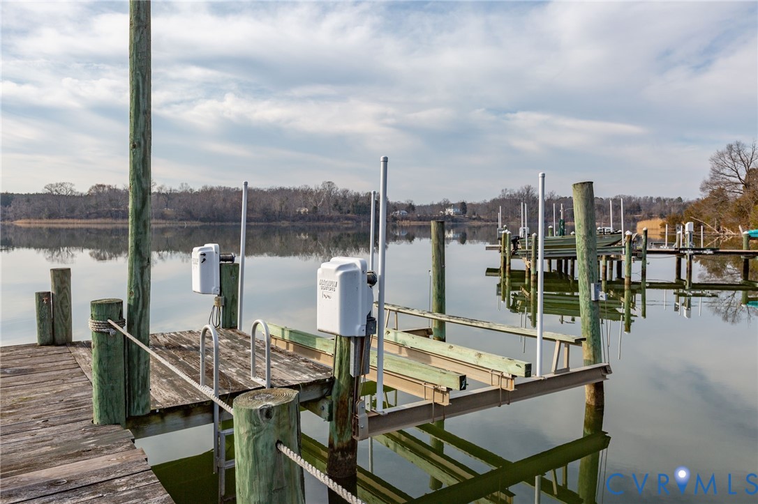 Dock area featuring a water view and boat lift