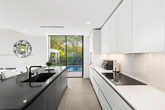 a kitchen with stainless steel appliances a sink a stove and a refrigerator