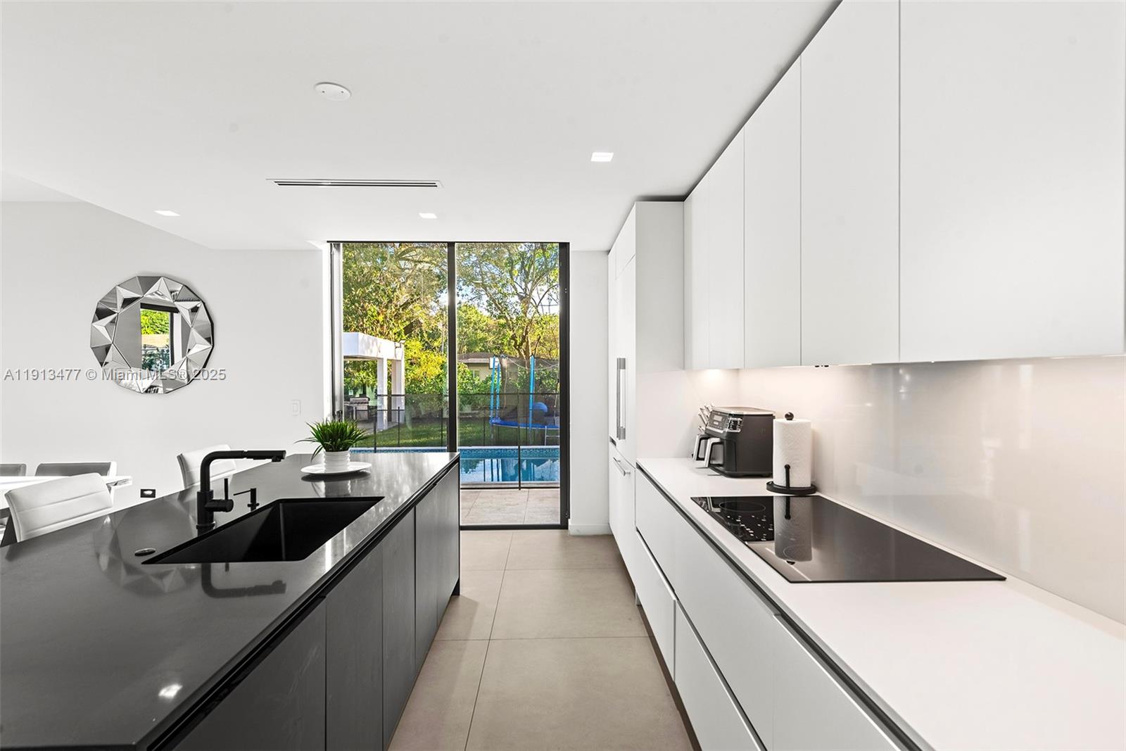 2572 Northeast 182nd Terrace North Miami Beach, FL 33160 - Photo 14 of 42 a kitchen with stainless steel appliances a sink a stove and a refrigerator