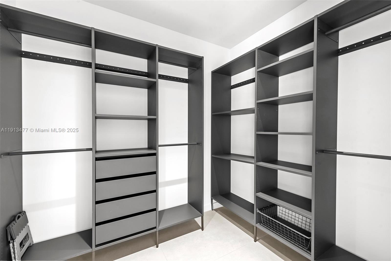 2572 Northeast 182nd Terrace North Miami Beach, FL 33160 - Photo 23 of 42 a view of walk in closet with empty racks