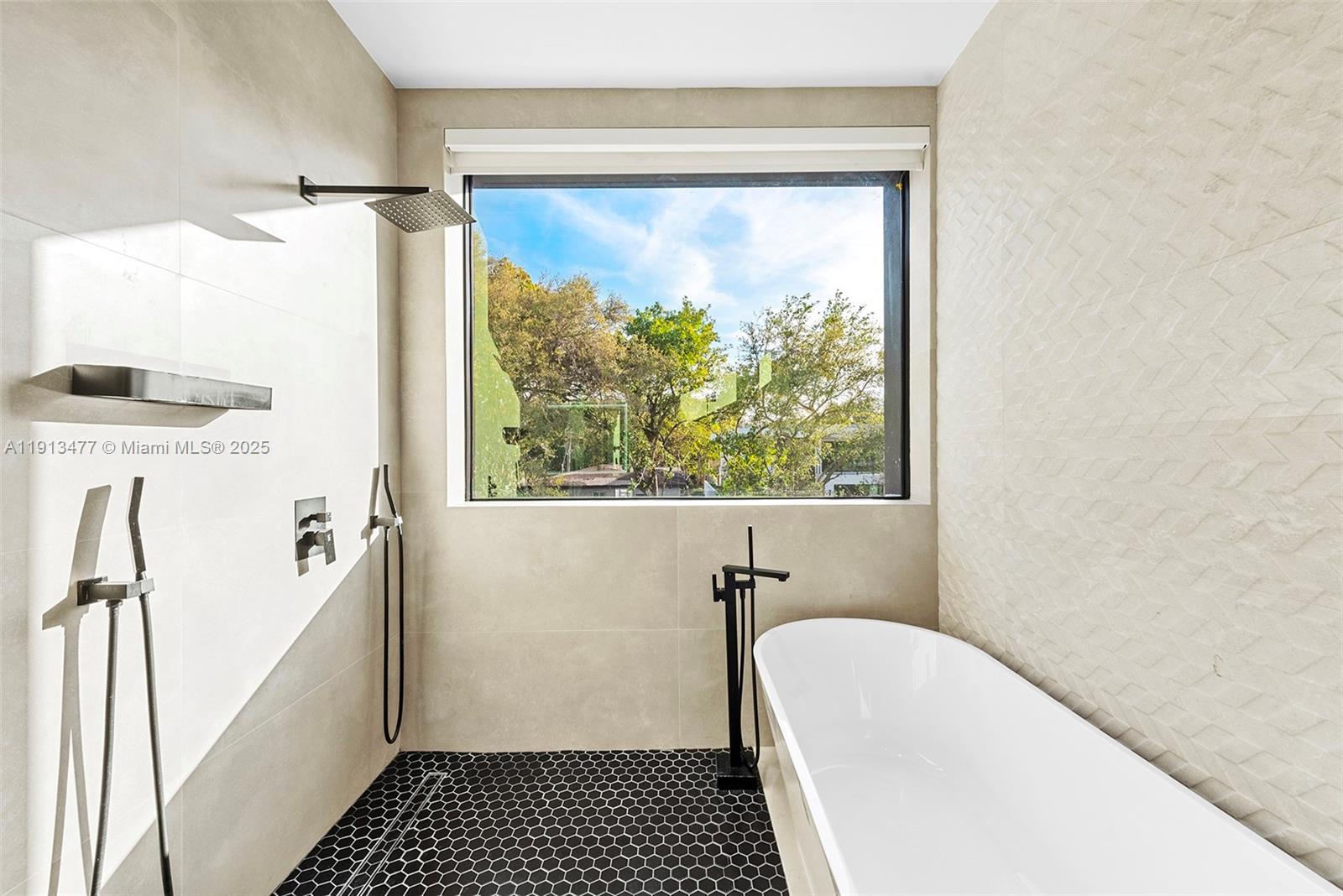 2572 Northeast 182nd Terrace North Miami Beach, FL 33160 - Photo 25 of 42 a bathroom with a tub and a window
