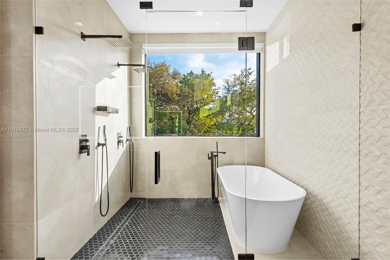 2572 Northeast 182nd Terrace North Miami Beach, FL 33160 - Photo 27 of 42 a bathroom with a bathtub and a shower