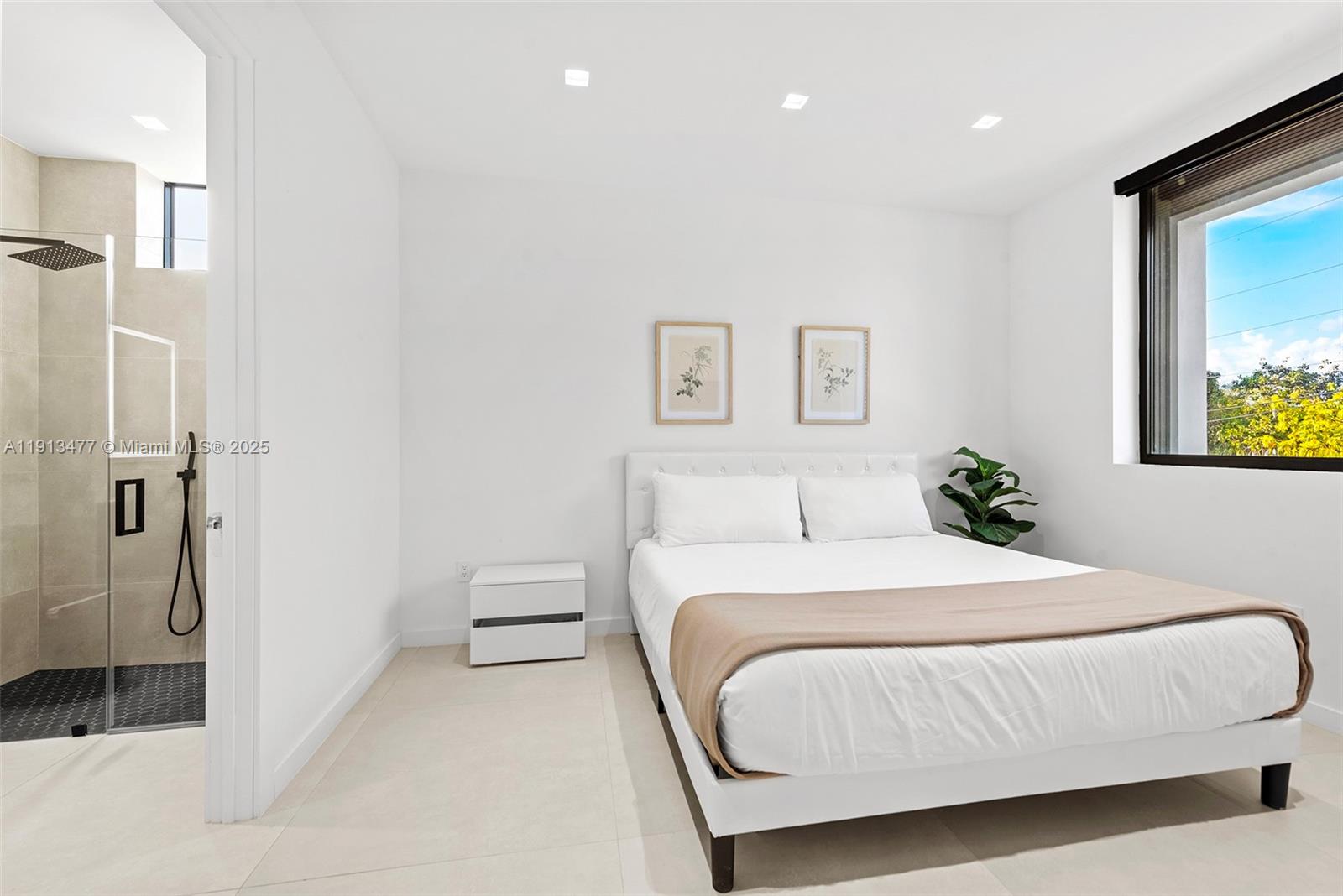 2572 Northeast 182nd Terrace North Miami Beach, FL 33160 - Photo 30 of 42 a bedroom with a bed and a painting on the wall