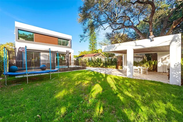 a view of house with backyard and patio