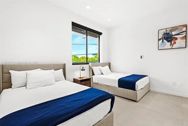 a bedroom with a bed and a large window