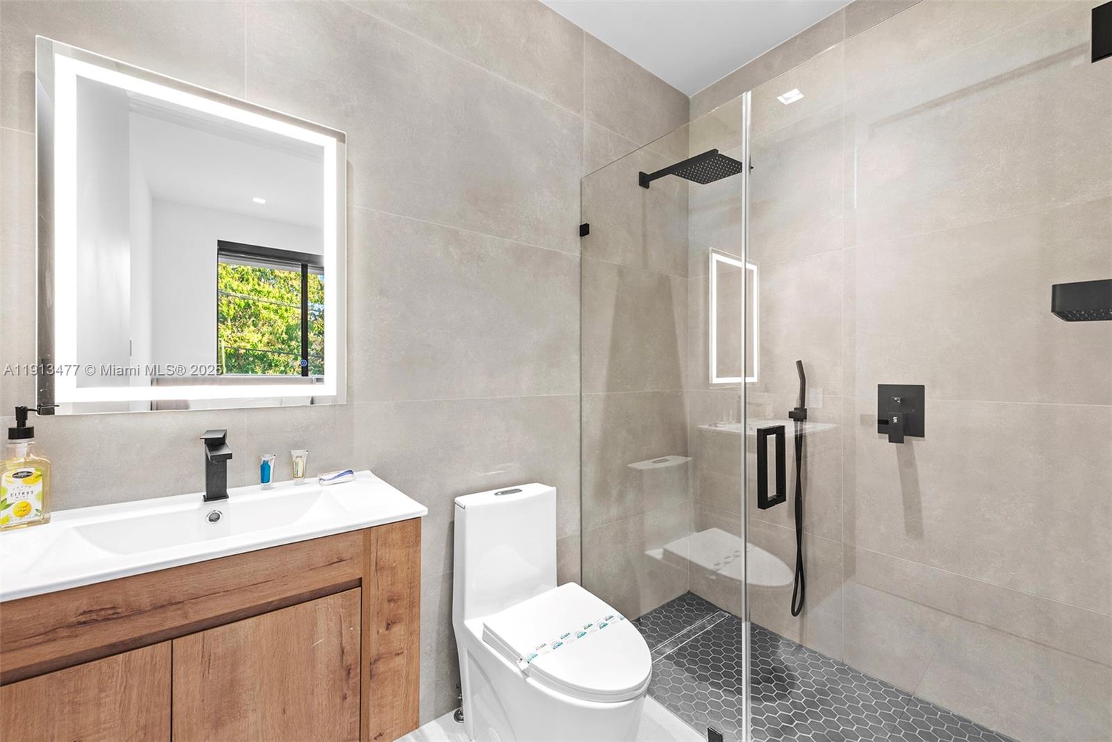 2572 Northeast 182nd Terrace North Miami Beach, FL 33160 - Photo 34 of 42 a bathroom with a sink a toilet and shower