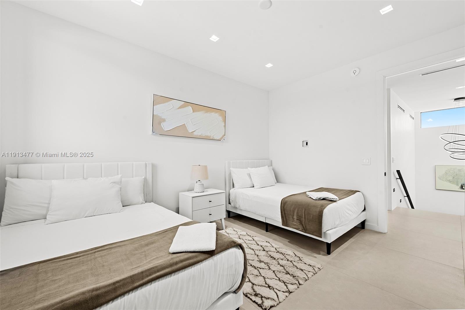 2572 Northeast 182nd Terrace North Miami Beach, FL 33160 - Photo 35 of 42 a bedroom with a bed and a couch