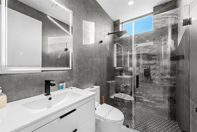 a bedroom with two beds and a window