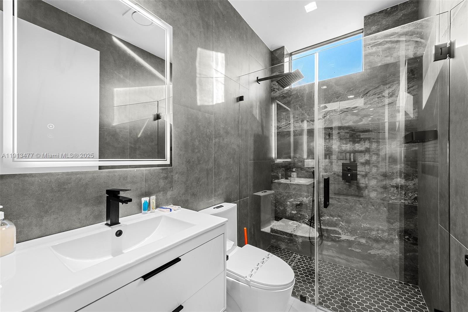 2572 Northeast 182nd Terrace North Miami Beach, FL 33160 - Photo 38 of 42 a bathroom with a sink toilet and shower