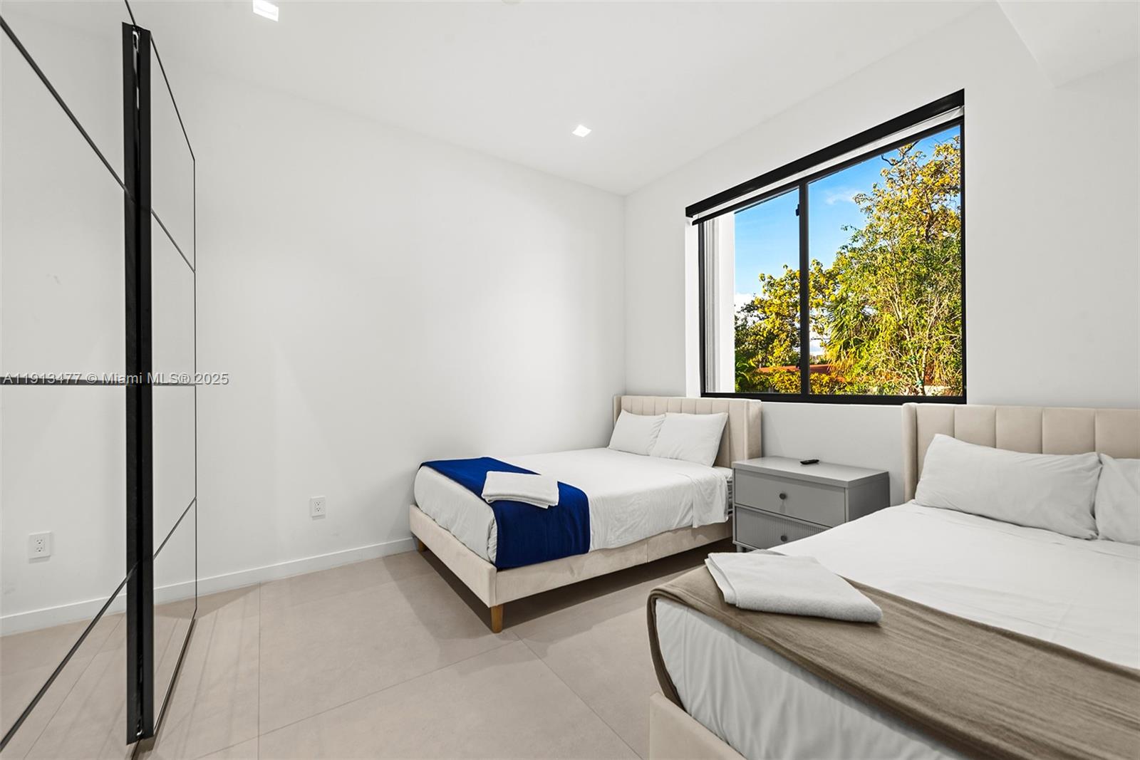 2572 Northeast 182nd Terrace North Miami Beach, FL 33160 - Photo 40 of 42 a living room with couches and a large window