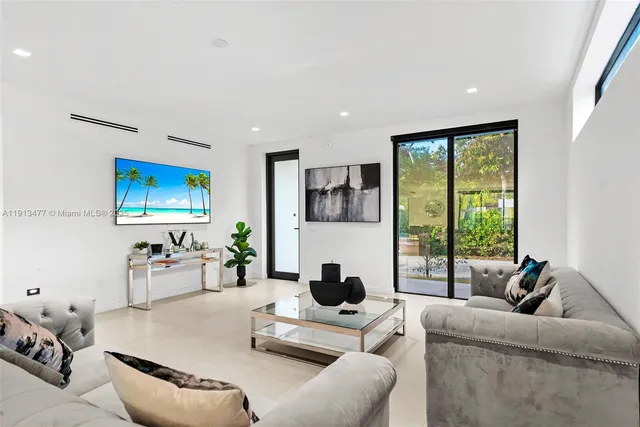 a living room with furniture and a large window