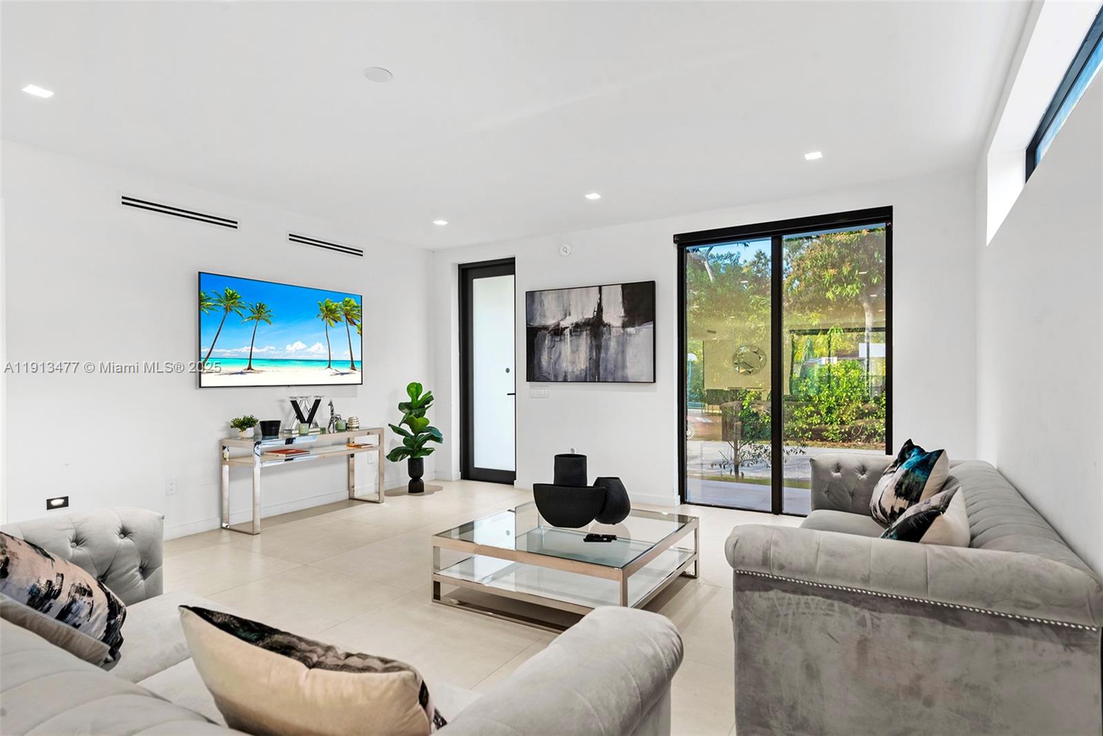 2572 Northeast 182nd Terrace North Miami Beach, FL 33160 - Photo 7 of 42 a living room with furniture and a large window