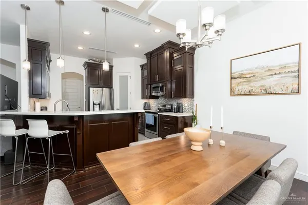 a large kitchen with a table and chairs