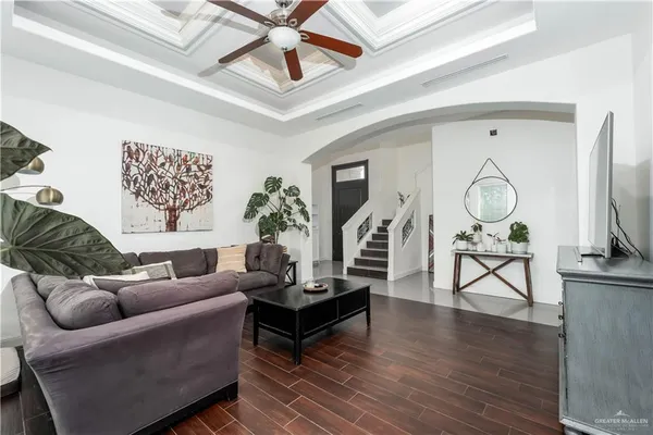 a living room with furniture a rug and a chandelier