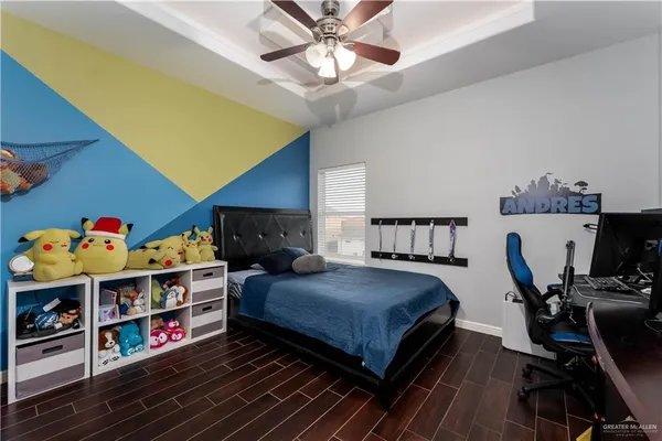 a bedroom with bed and a chandelier
