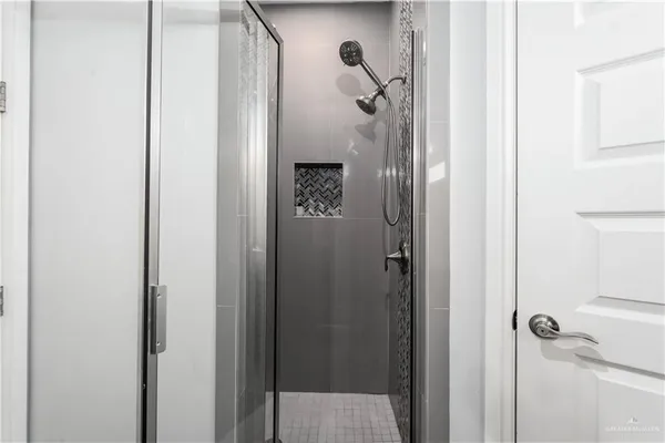 a bathroom with a glass shower door