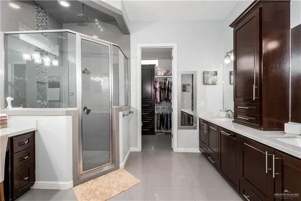 a large kitchen with stainless steel appliances granite countertop a refrigerator and a sink