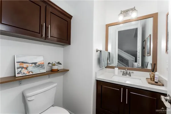 a bathroom with a toilet a sink and a mirror
