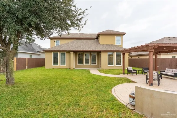 a view of a house with a backyard