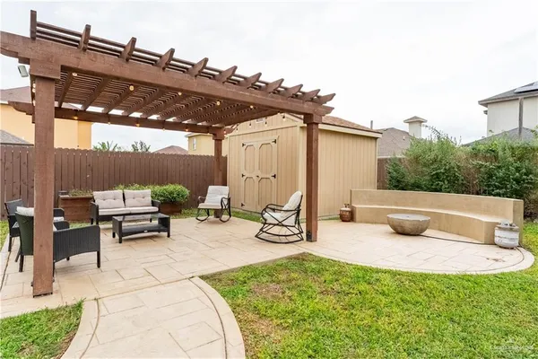 a view of a patio with a table and chairs under an umbrella