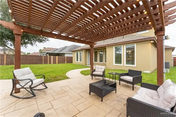 a view of a house with backyard and sitting area