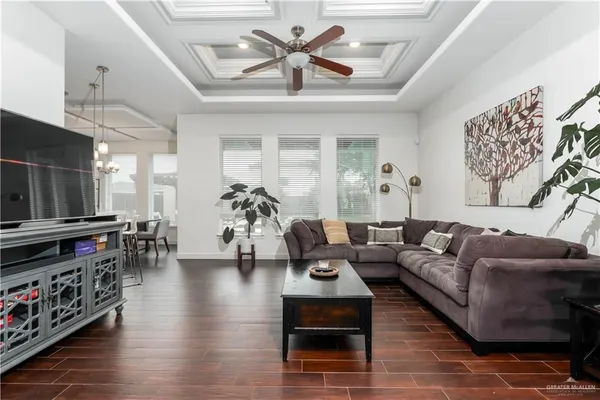 a living room with furniture and wooden floor