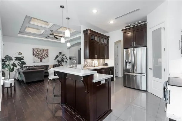 a kitchen with a refrigerator a sink dishwasher stove and oven with wooden floor