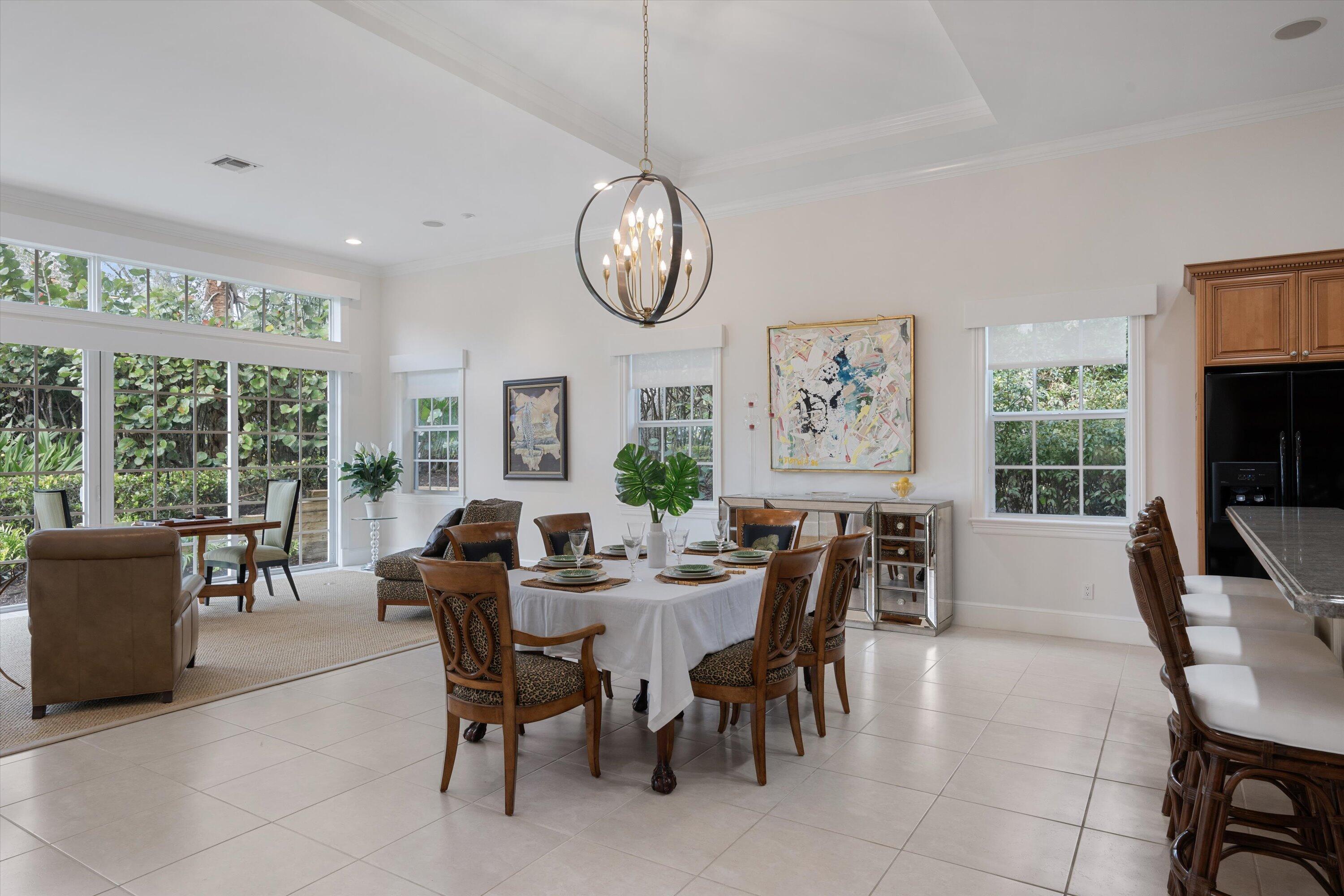 113 Caballo Lane Jupiter, FL 33458 - Photo 13 of 51 a view of a dining room with furniture large windows and a chandelier