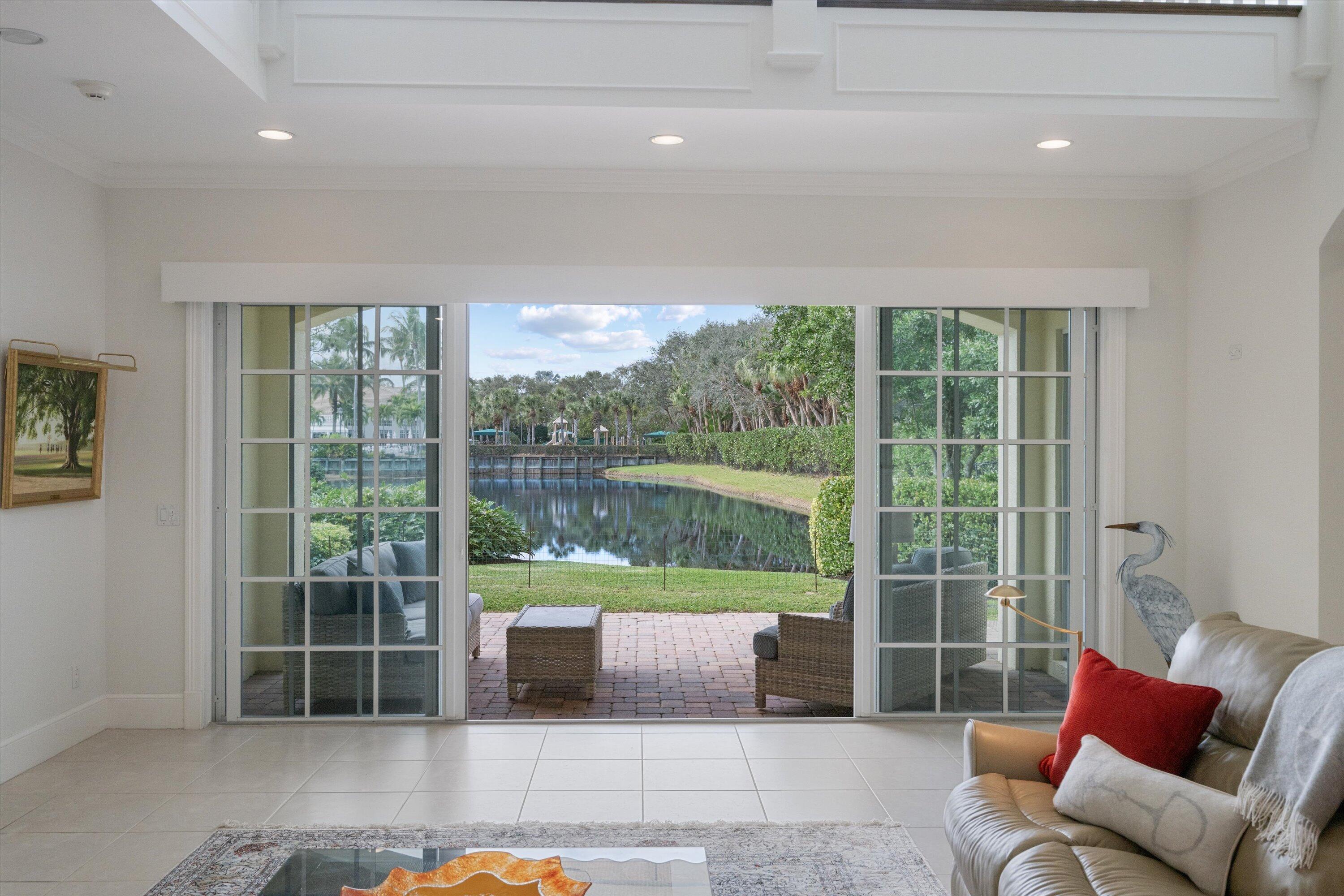 113 Caballo Lane Jupiter, FL 33458 - Photo 22 of 51 a living room with furniture and a floor to ceiling window