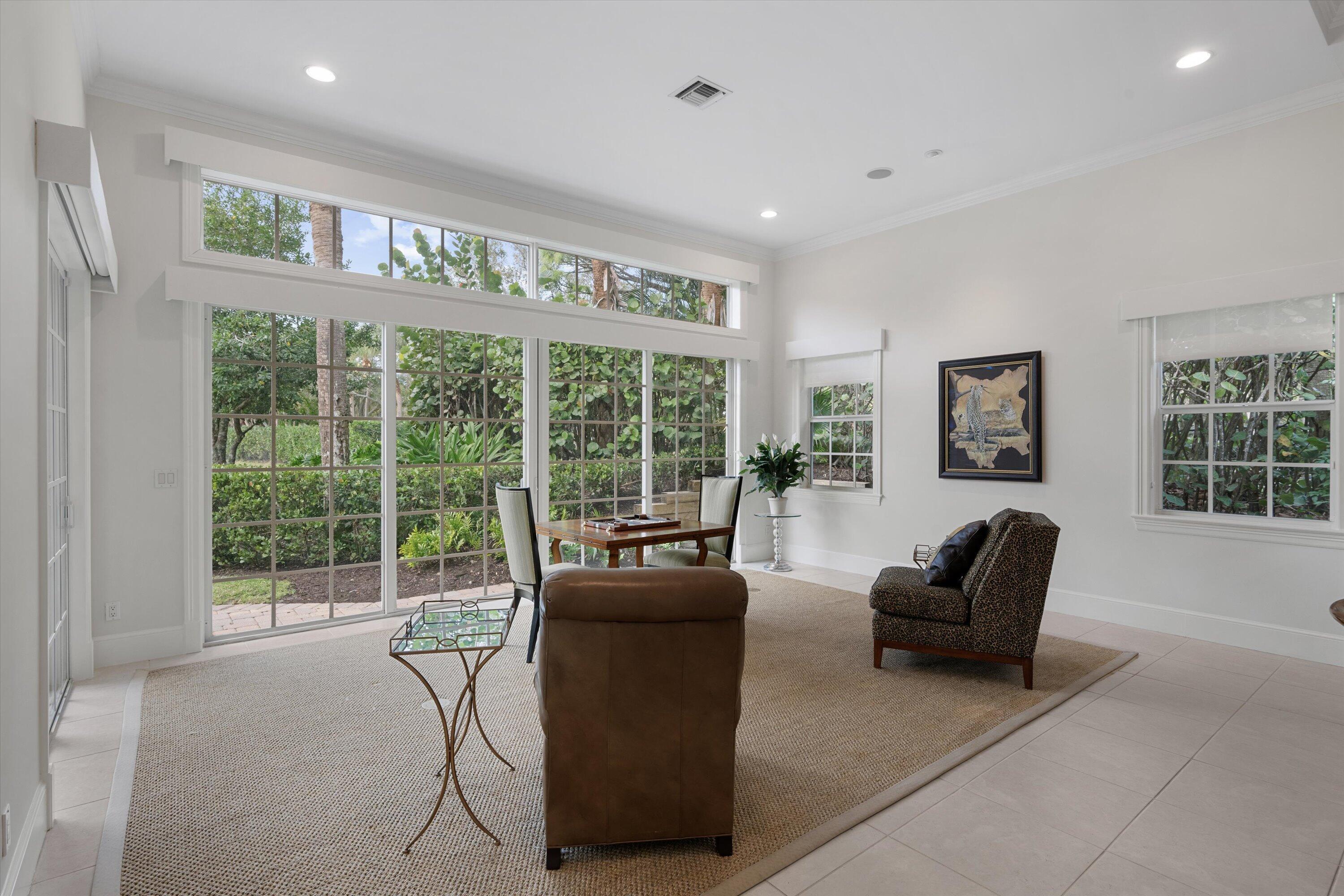 113 Caballo Lane Jupiter, FL 33458 - Photo 26 of 51 a living room with furniture and a floor to ceiling window