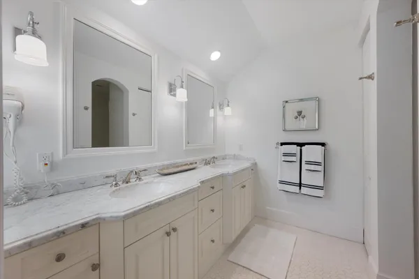a spacious bathroom with a double vanity sink and a