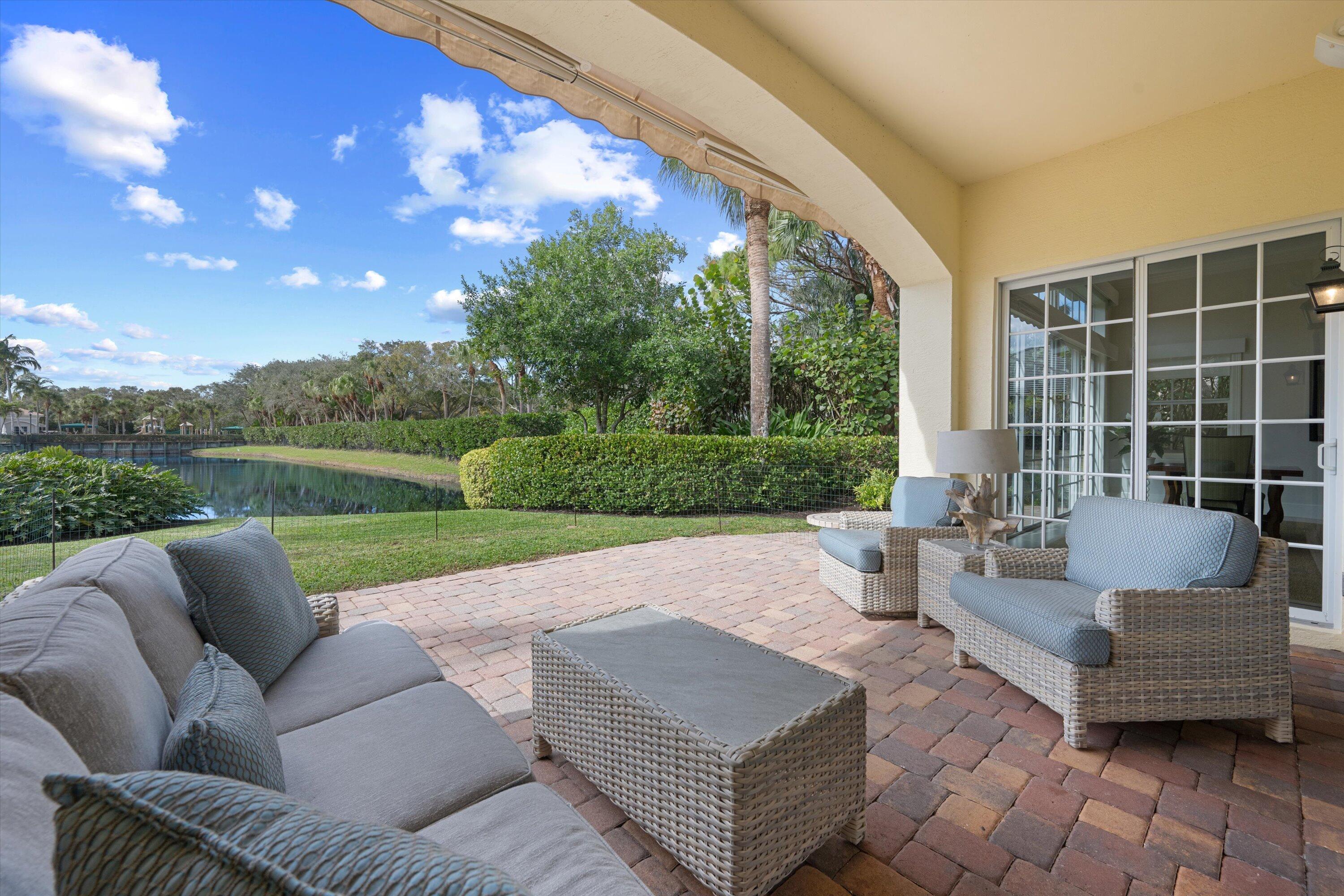 113 Caballo Lane Jupiter, FL 33458 - Photo 42 of 51 a view of a patio with couches and a big yard