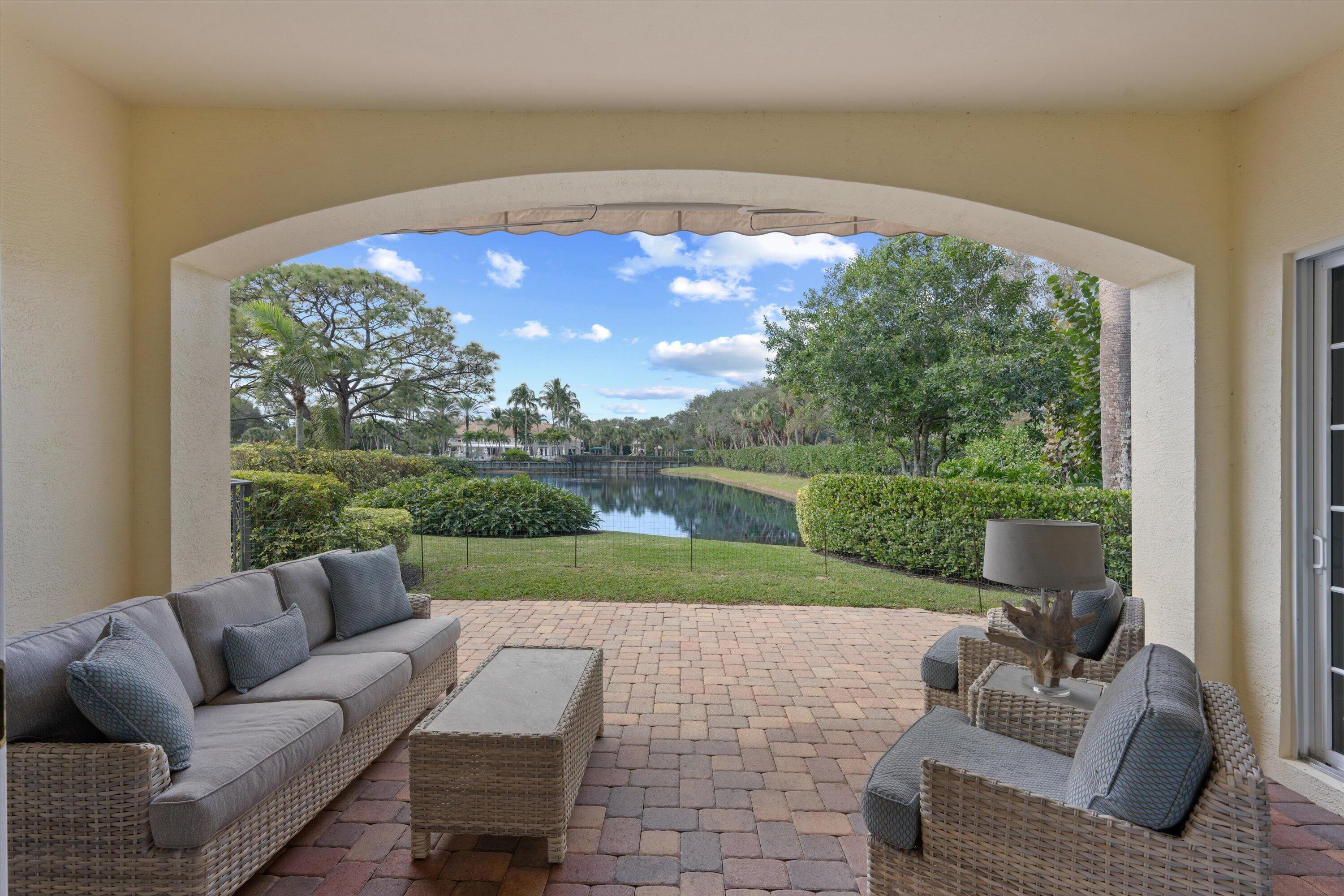 113 Caballo Lane Jupiter, FL 33458 - Photo 43 of 51 a view of a patio with couches chairs and a yard